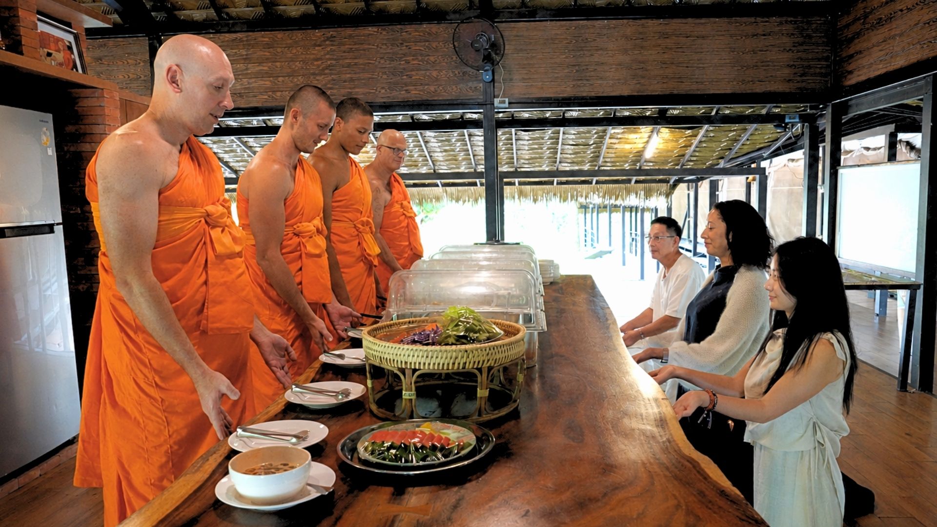 Guests offering the midday meal to resident monks